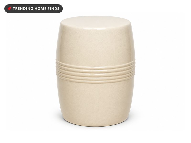 A cream glazed ceramic drum garden stool with a raised relief band around its middle.
