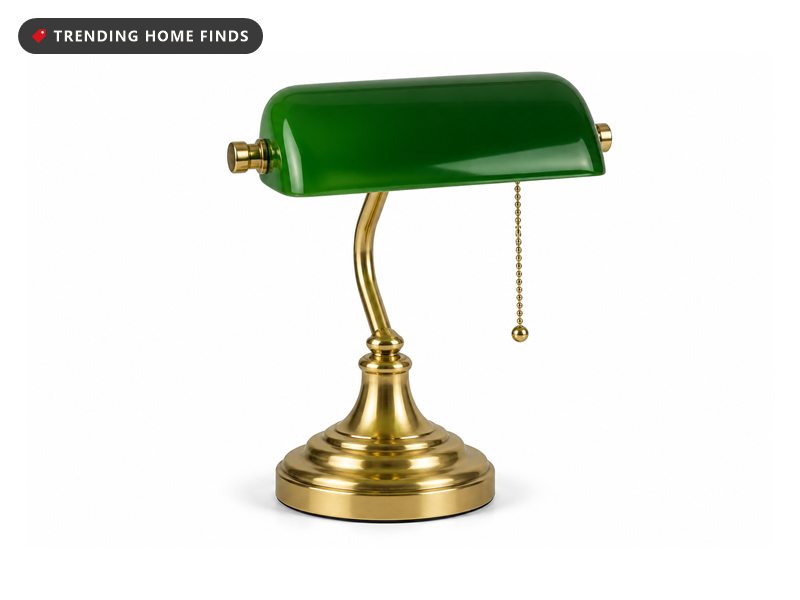 Bankers desk lamp with an emerald green glass shade and polished brass base with a hanging pull chain.