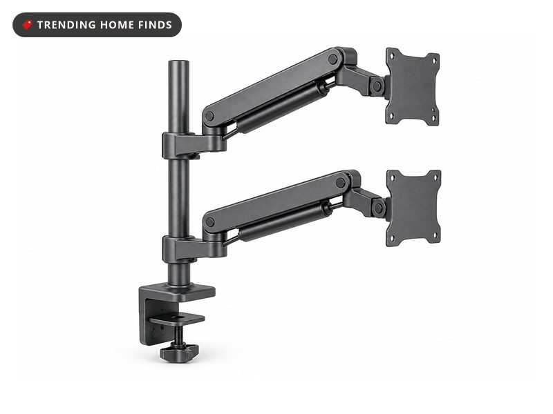 Dark gunmetal dual monitor mount with a C clamp base, an upright pole and two articulated gas spring arms.