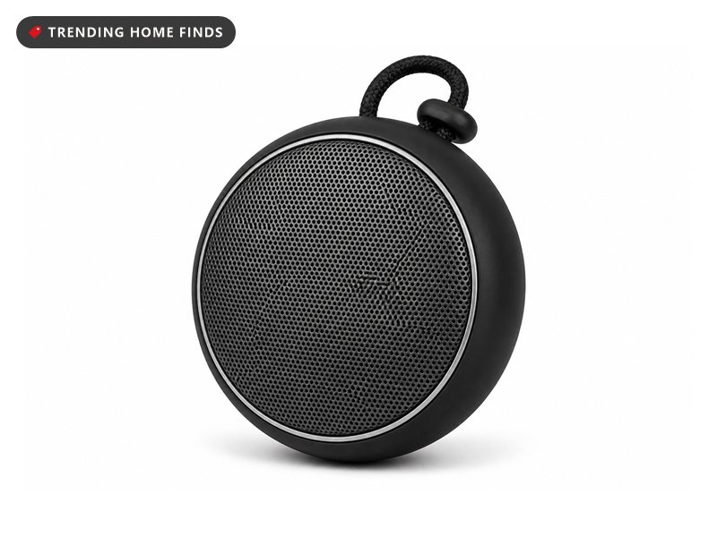 Round waterproof speaker with a dark grey mesh grille, black rubber rim and a braided lanyard loop.
