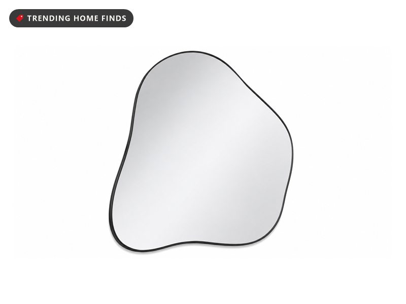 Irregular asymmetrical wall mirror with a curved organic outline and a thin black frame