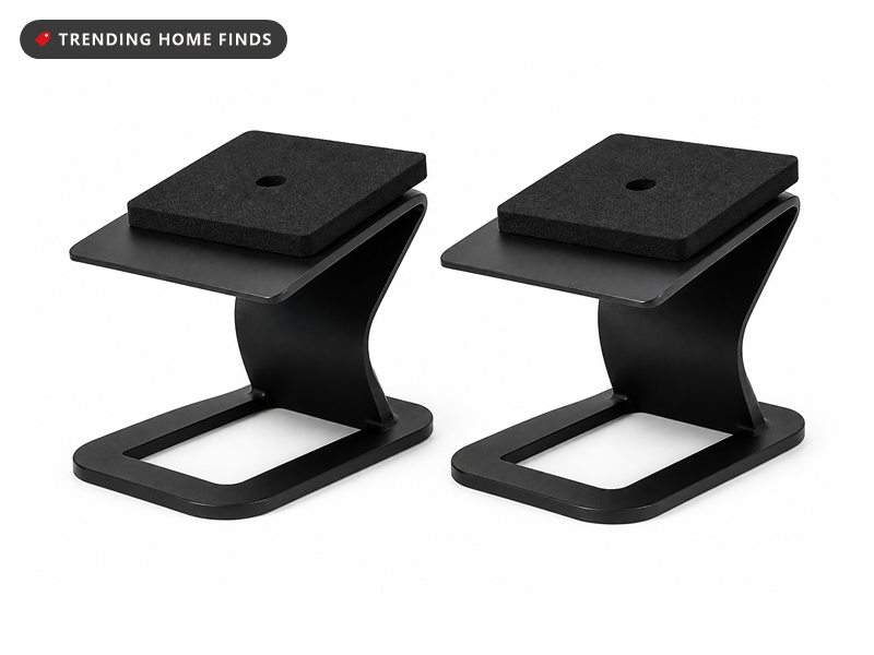 Pair of black steel desktop speaker stands with open hoop bases, angled top plates and black foam pads.