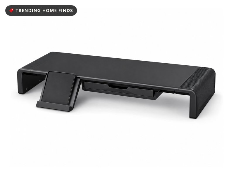 Black monitor stand riser with a pull-out storage drawer beneath the platform