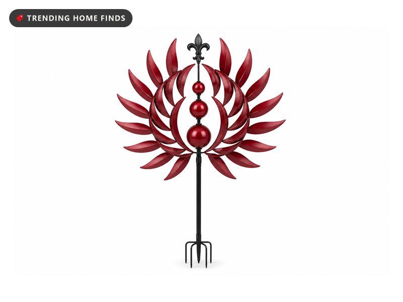 A tall burgundy metal kinetic wind spinner with two rings of pointed petals, three stacked red spheres and a black pole.