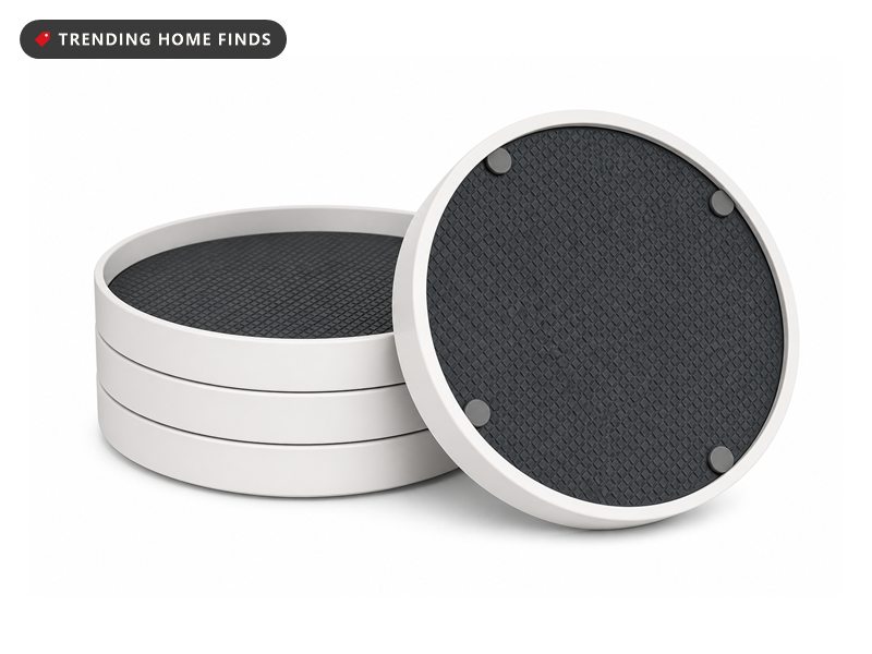 Four round turntables with raised white rims and dark gray non slip liners stacked together.
