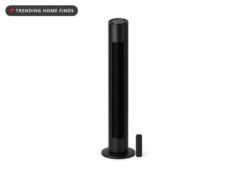 Tall black Levoit bladeless tower fan with a slim vertical body, a control panel on top and its remote at the base