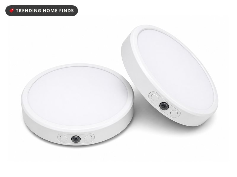 Round white rechargeable ceiling light with a broad flat diffuser and a small motion sensor set into the rim.