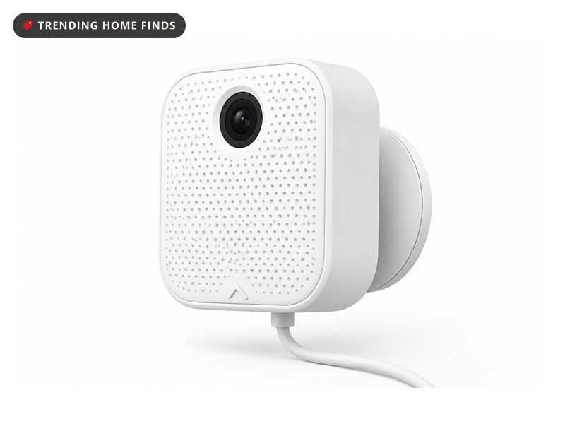 Small white window security camera with a dotted grille face and a magnetic mount, with a USB-C cable.