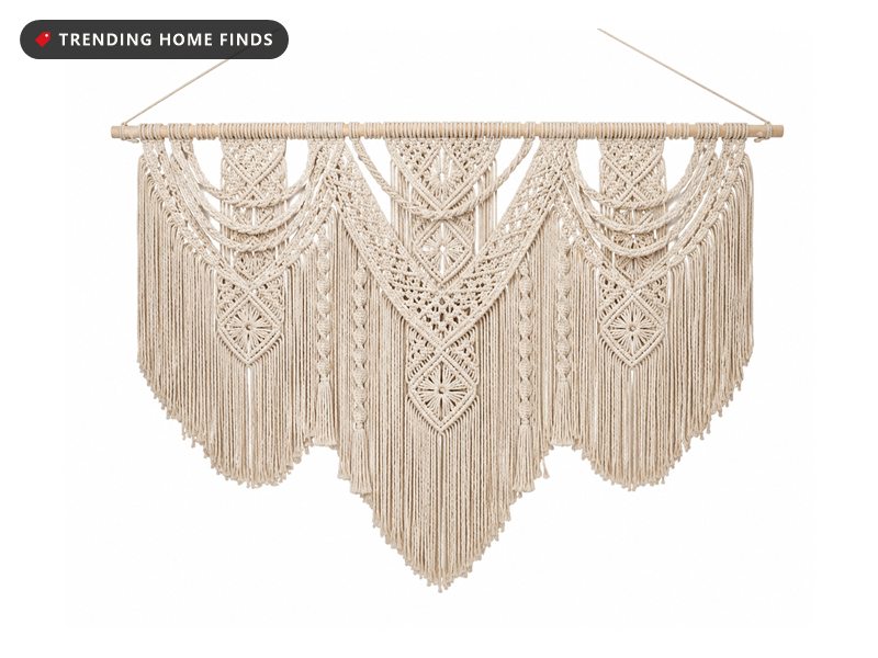 Wide beige cotton macrame wall hanging with knotted diamond patterns and long fringe, suspended from a wooden dowel