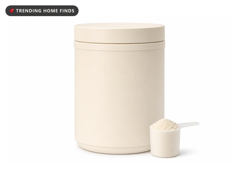 Tub of magnesium glycinate nighttime drink mix with its scoop, on a white background
