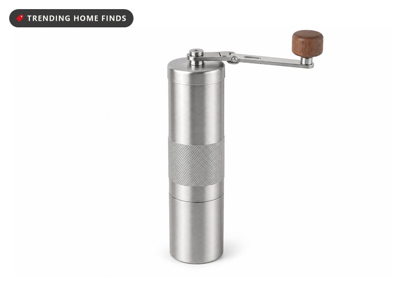Stainless steel hand-crank burr coffee grinder with a wooden knob, on a white background