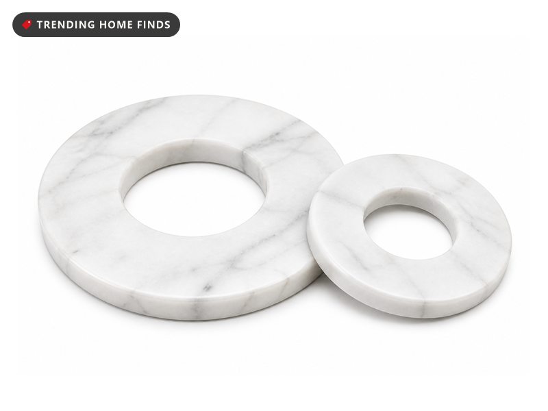 Two white marble rings, one larger and one smaller, lying side by side with soft gray veining.