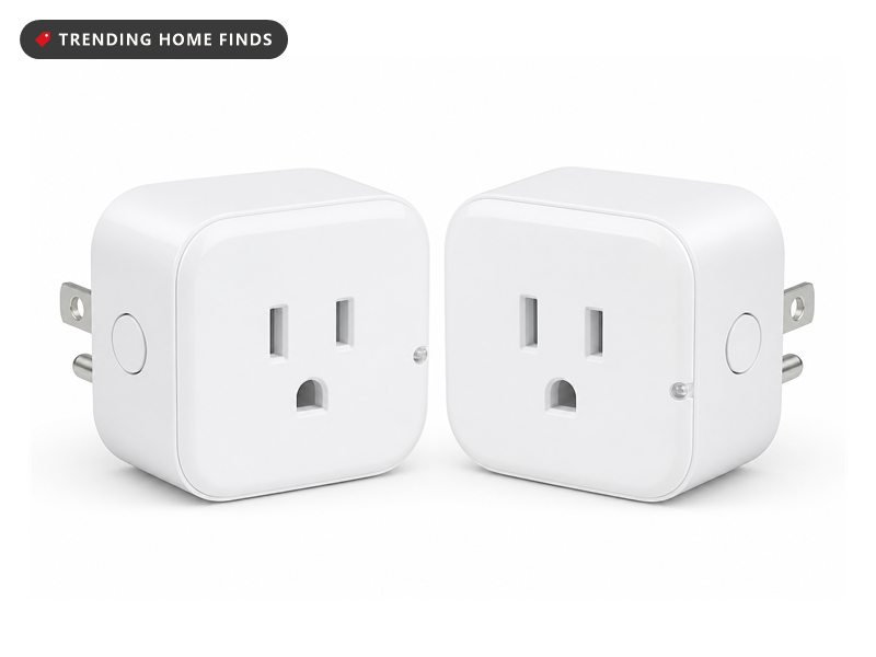 Two small white smart plugs in a baseboard outlet behind a sofa in cool pre-dawn light, a lamp cord running into one of them.