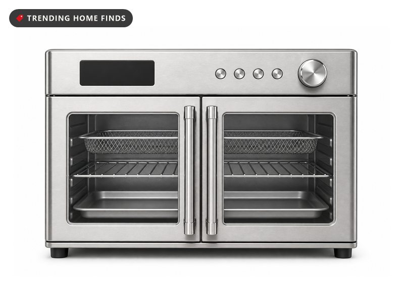 Stainless steel Midea french door toaster oven and air fryer with two glass doors, a digital display reading 450 degrees and two loaded racks inside