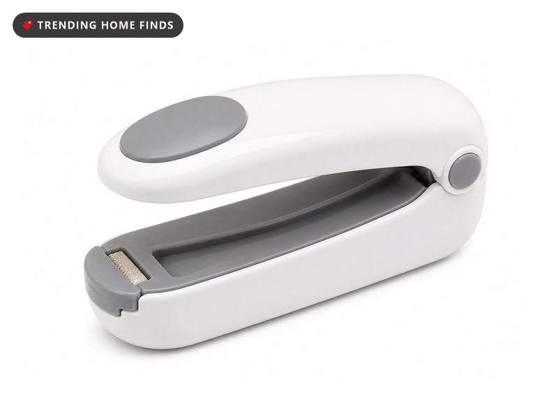 White and grey FEPPO handheld mini bag sealer with a round press button and a cutter on the underside