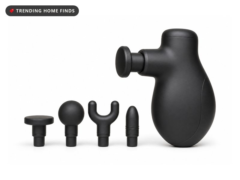 Small black percussion massage gun with four attachment heads in an open case, on a white background