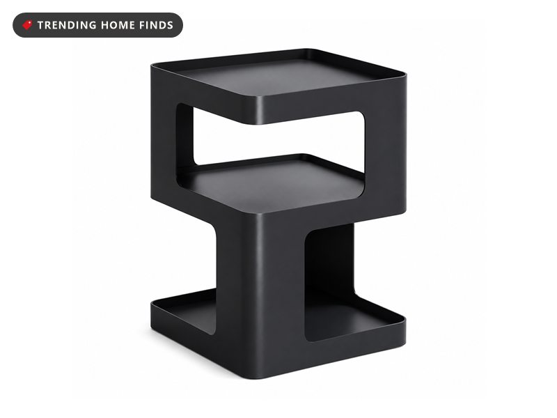 Black metal side table with three open storage tiers in a cube silhouette