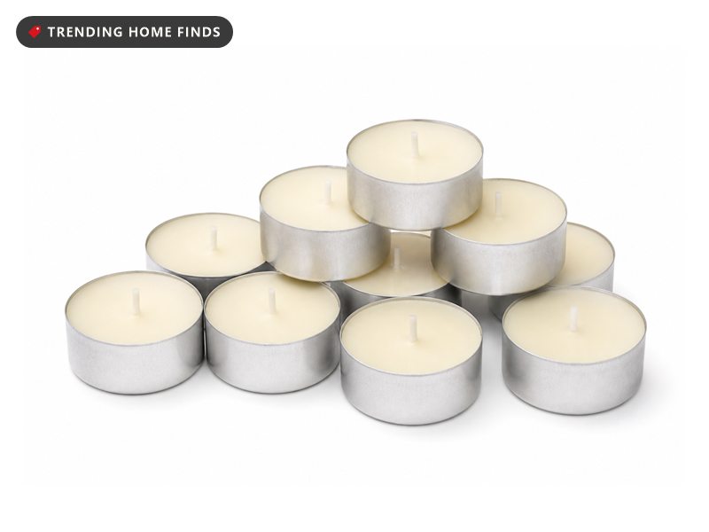 Cream tea light candles in plain silver aluminium cups, grouped together.