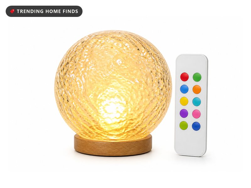 Textured crystal globe mood lamp glowing amber on a wooden base, shown with remote and color options