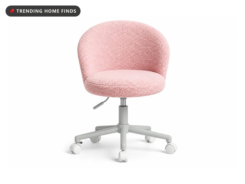 Armless rolling vanity chair upholstered in pale pink teddy fleece, on a light grey five star base with white castors.