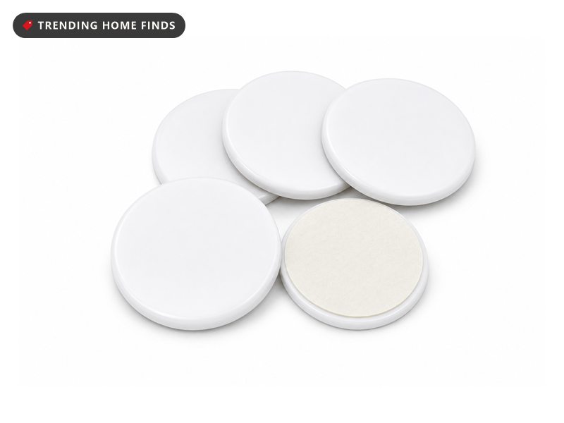 Small round white NFC smart automation tags with adhesive backs, on a white background