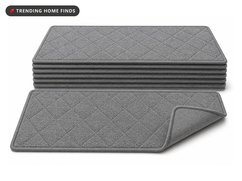 Gray quilted carpet stair treads with bound edges laid along a run of oak stairs.