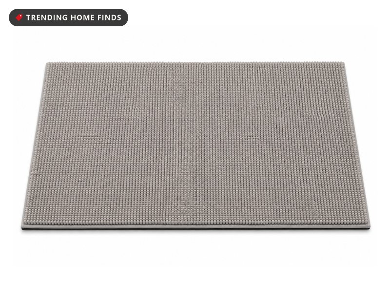 Rectangular high pile chenille bath rug in soft warm gray, its face covered in dense upright loops.