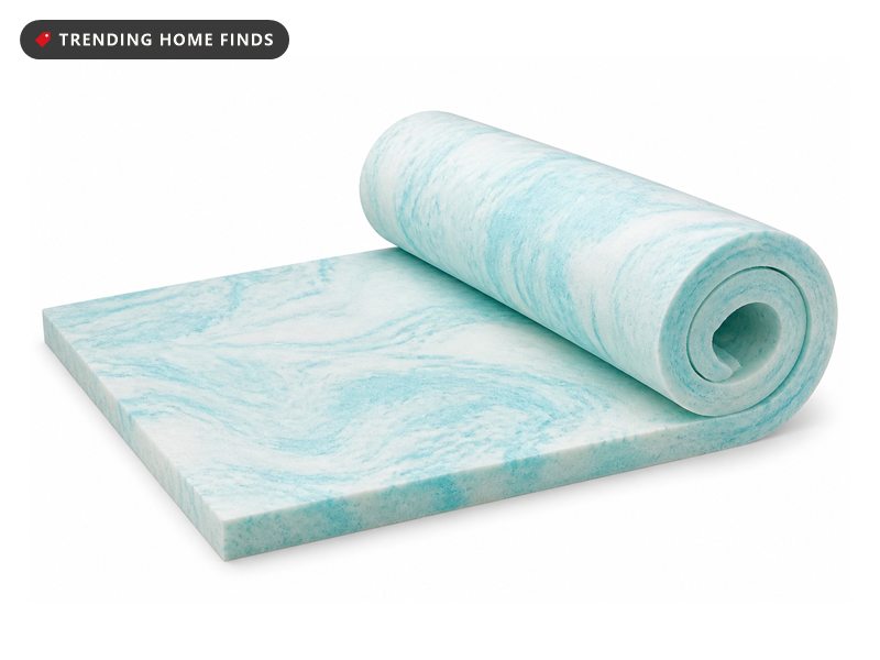 Two inch memory foam mattress topper marbled with pale aqua cooling gel, rolled back at one end.
