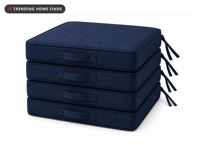 Four thick navy blue outdoor seat cushions with piped edges, side carry straps and corner ties.