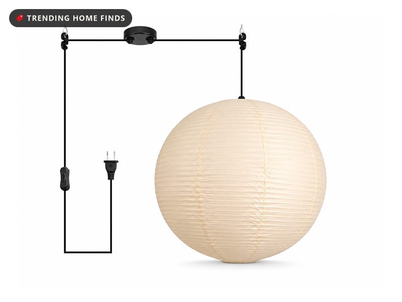 Round off-white paper lantern pendant hanging from a black plug-in cord kit with an inline switch