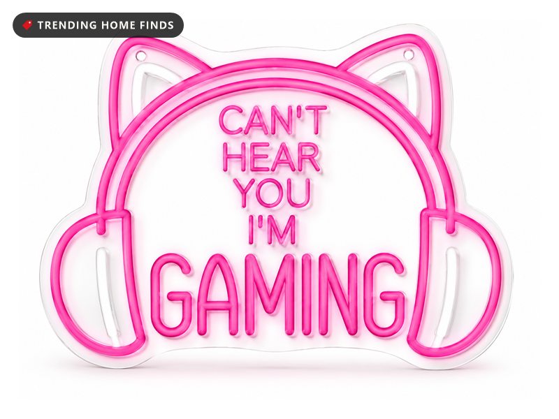 Neon sign shaped like a pair of headphones with cat ears, mounted on a clear backing, reading CAN'T HEAR YOU I'M GAMING in pink neon tubing