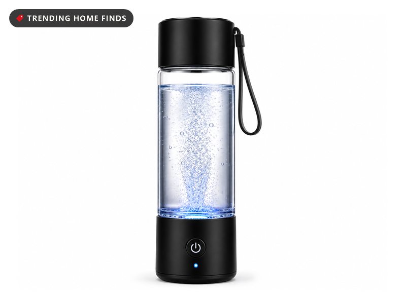 Clear PIURIFY hydrogen water bottle with a black lid and base, a wrist strap and a lit power button, filled with bubbling water