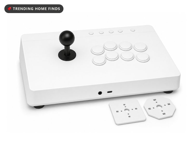 White arcade fight stick with a ball top lever and swappable gate plates, on a white background