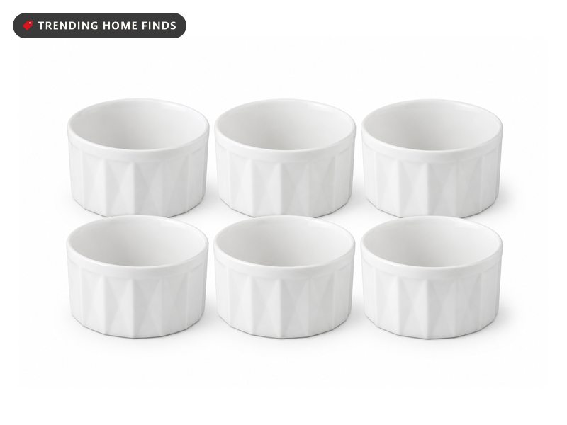 Six white porcelain ramekins with faceted geometric sides, arranged in two rows.