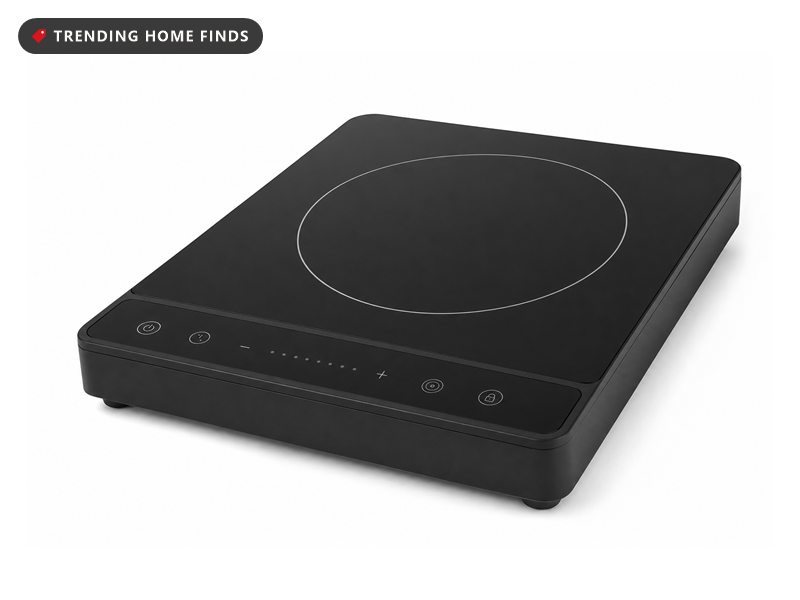 Slim black portable induction cooktop with a touch control strip, on a white background