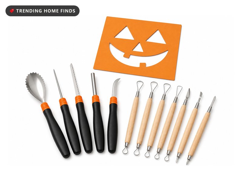 Eleven stainless pumpkin carving tools with black and wooden handles laid beside a cut paper stencil.