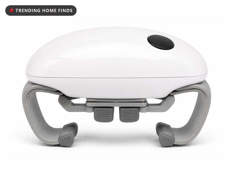White Robotwist automatic jar opener with grey side arms clamped onto the lid of a jar of red preserve