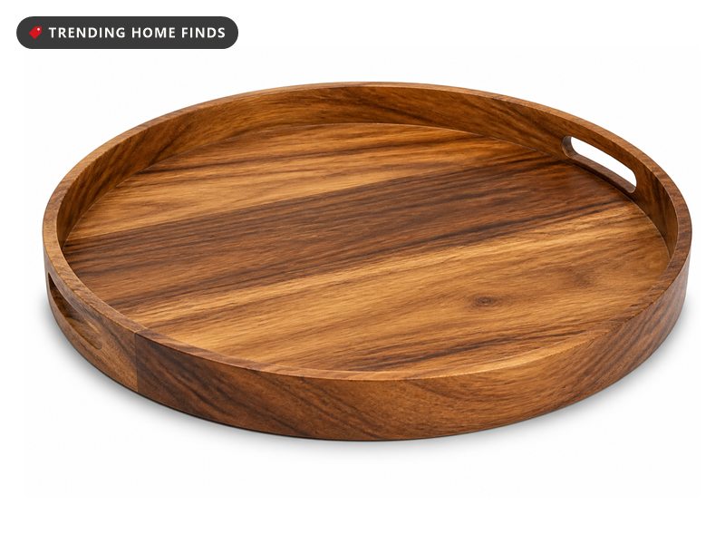 A large round acacia wood tray with two cut in handles and a low rim.