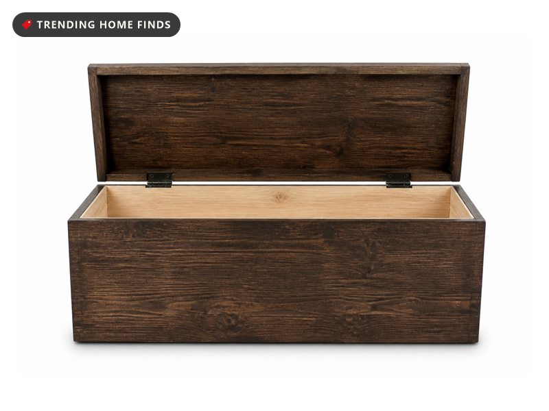 A dark brown solid wood storage trunk with its lid propped open on metal hinges.