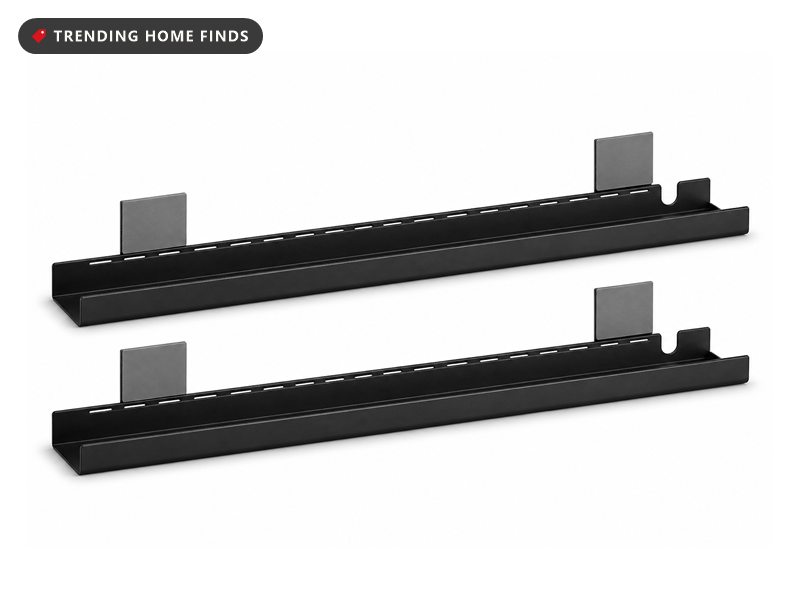 Two black open-sided under desk cable management trays stacked at an angle, each with 3M adhesive pads on its mounting flanges