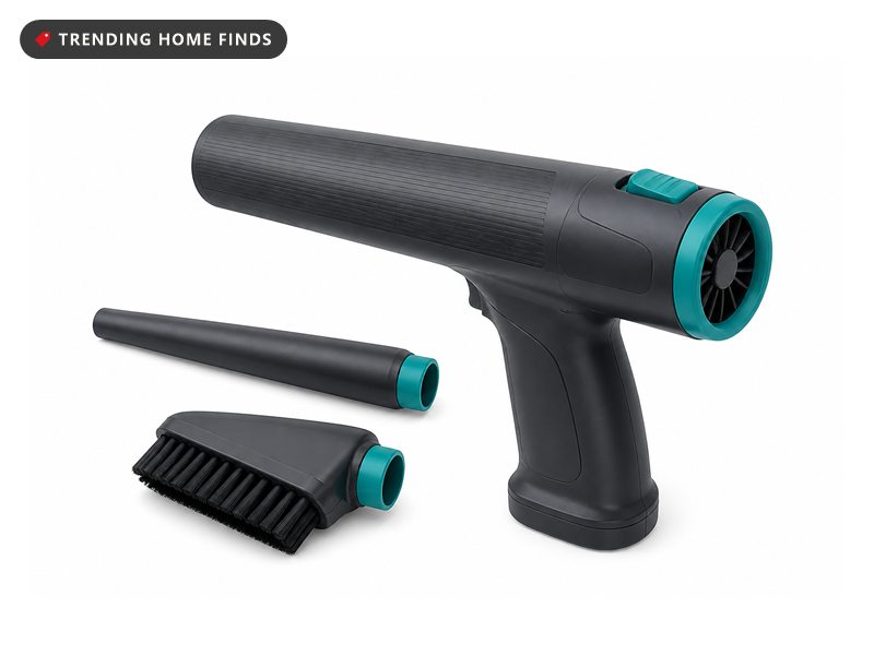 Handheld grey and teal cordless air blasting tool with an extension wand and a stiff bristled brush head.