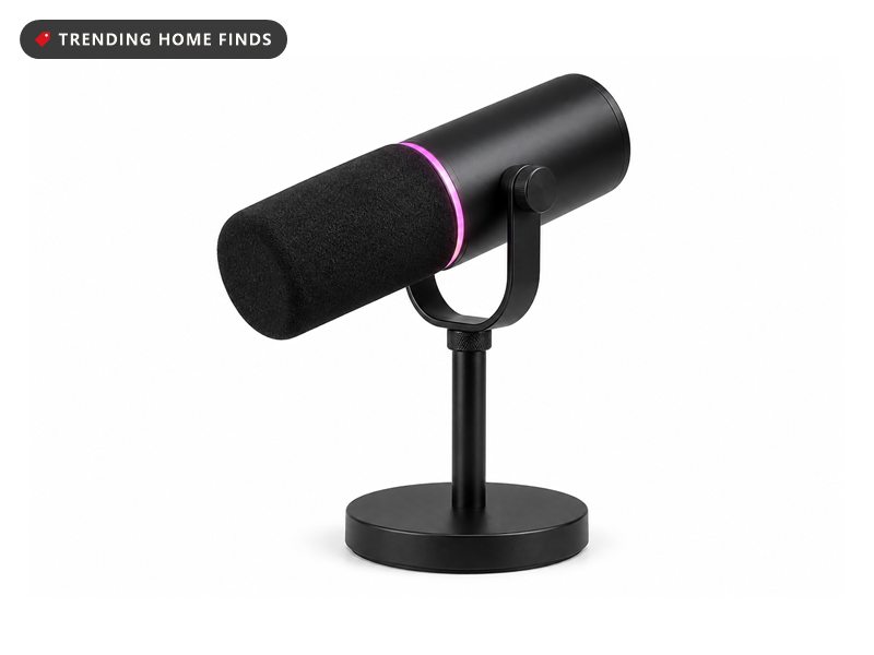 Black Shure dynamic podcast microphone with a foam windscreen, mounted on a round base desktop stand