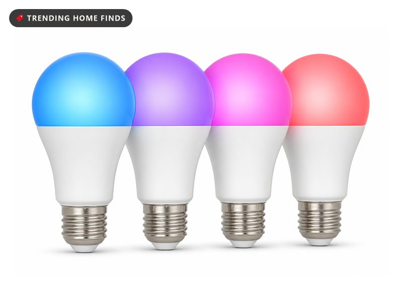 Four A19 smart light bulbs with white bodies, frosted domes and silver screw bases, lit in different colors.