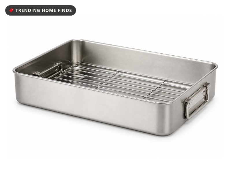A stainless steel roasting pan with a flat wire rack resting inside it.