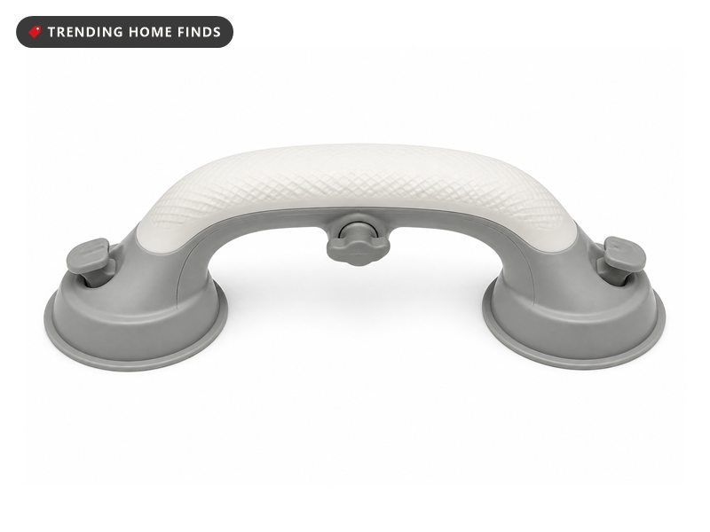 A white and gray molded shower grab handle with a textured grip and round suction pads at each end.