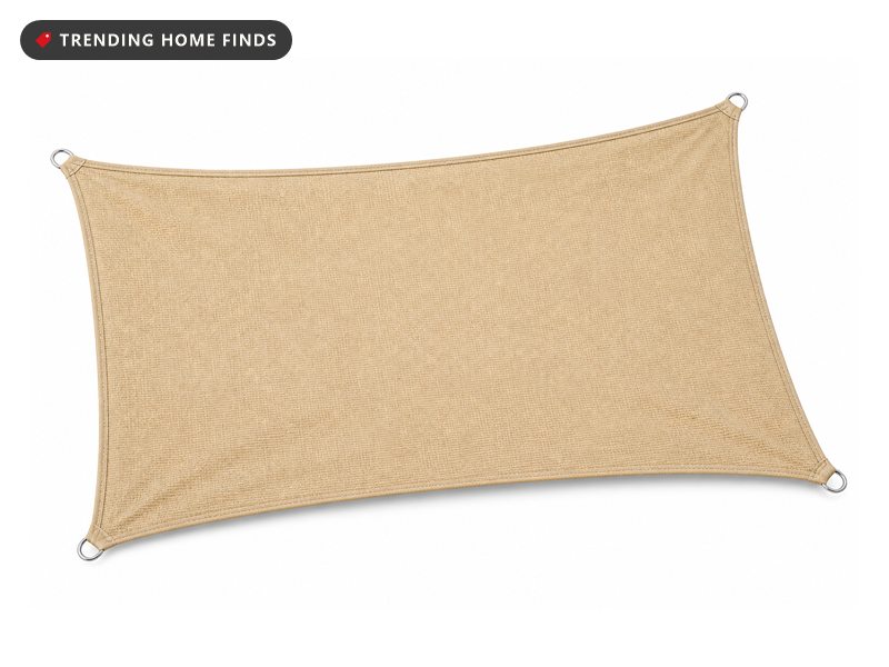A sand colored rectangular shade sail of woven mesh with curved edges and a steel D-ring at each corner.