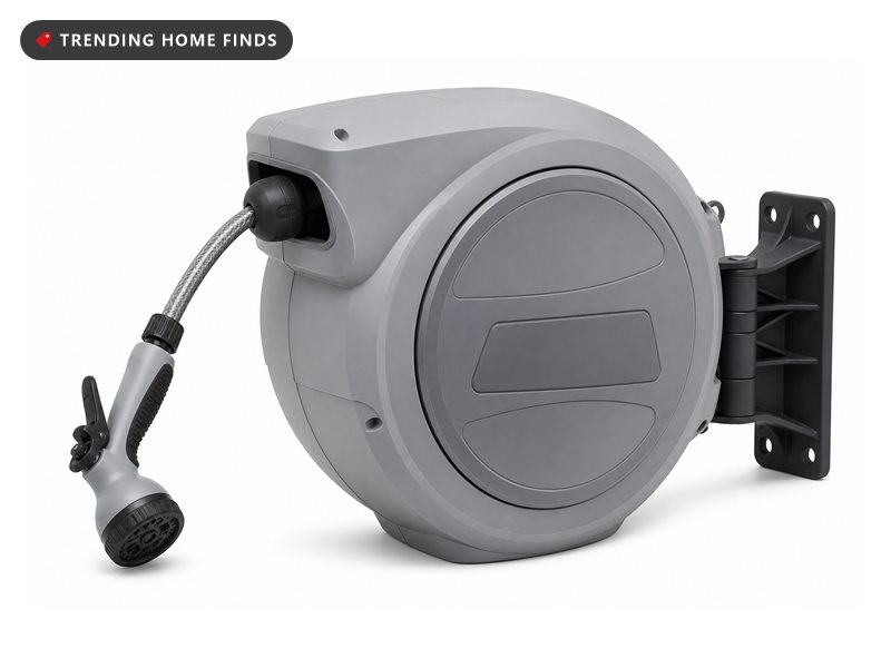 Grey wall mounted retractable garden hose reel in a rounded housing with a spray nozzle, on white.