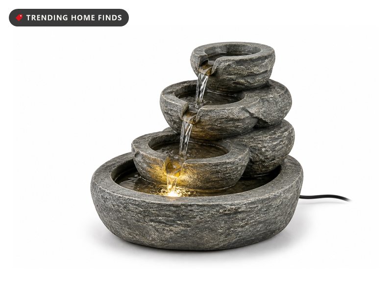 Small tiered stone tabletop water fountain with a soft built-in LED glow on a desk corner