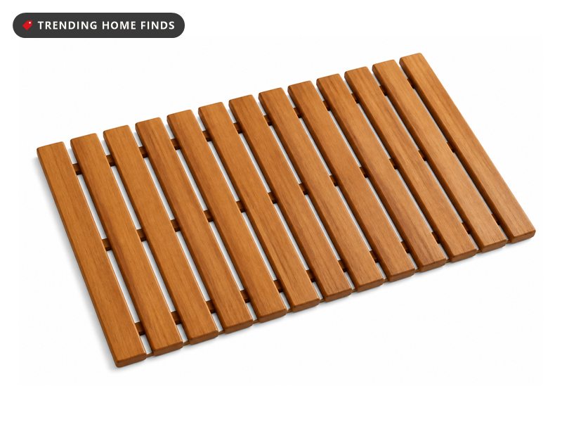 A slatted teak wood bath mat with even gaps between the slats.