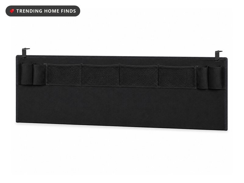 Black under-desk privacy panel with a row of storage pockets along the front
